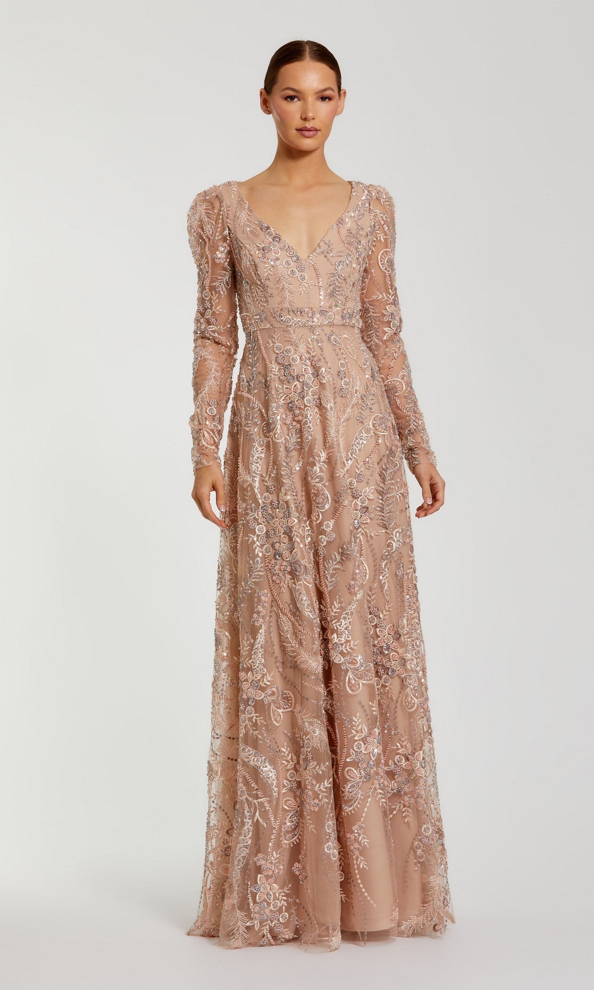 A woman wearing the Mac Duggal 68908 long formal dress in taupe, featuring long sleeves and floor-length design with intricate lace and sequin detailing, stands against a plain light background—an elegant choice for a mother-of-the-bride dress.